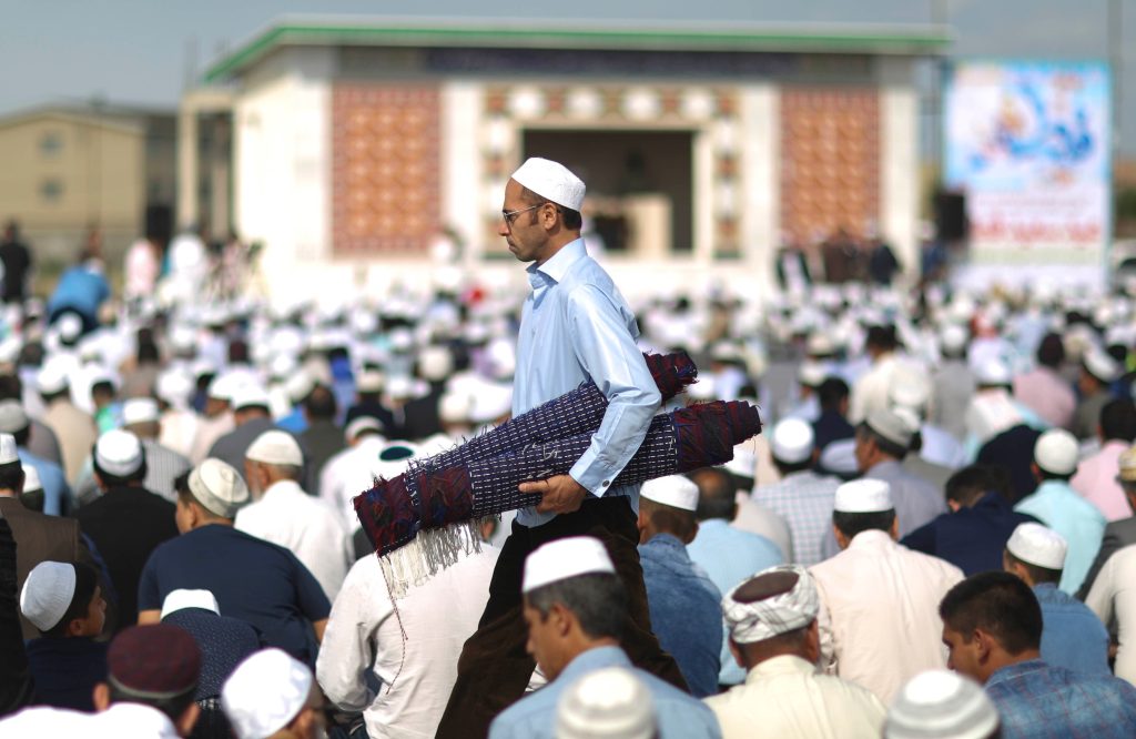 People pray at the first day of Eid Al Fitr