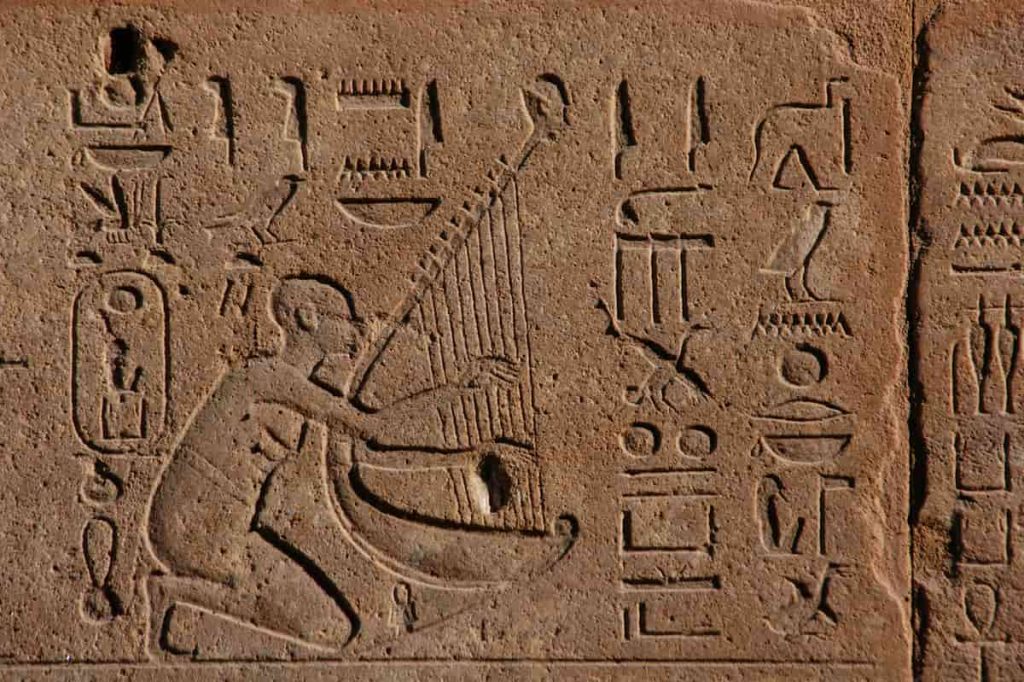 Egyptian musician in a bas-relief from Hatshepsut's Red Chapel in Karnak Temple near Luxor (Thebes), Egypt