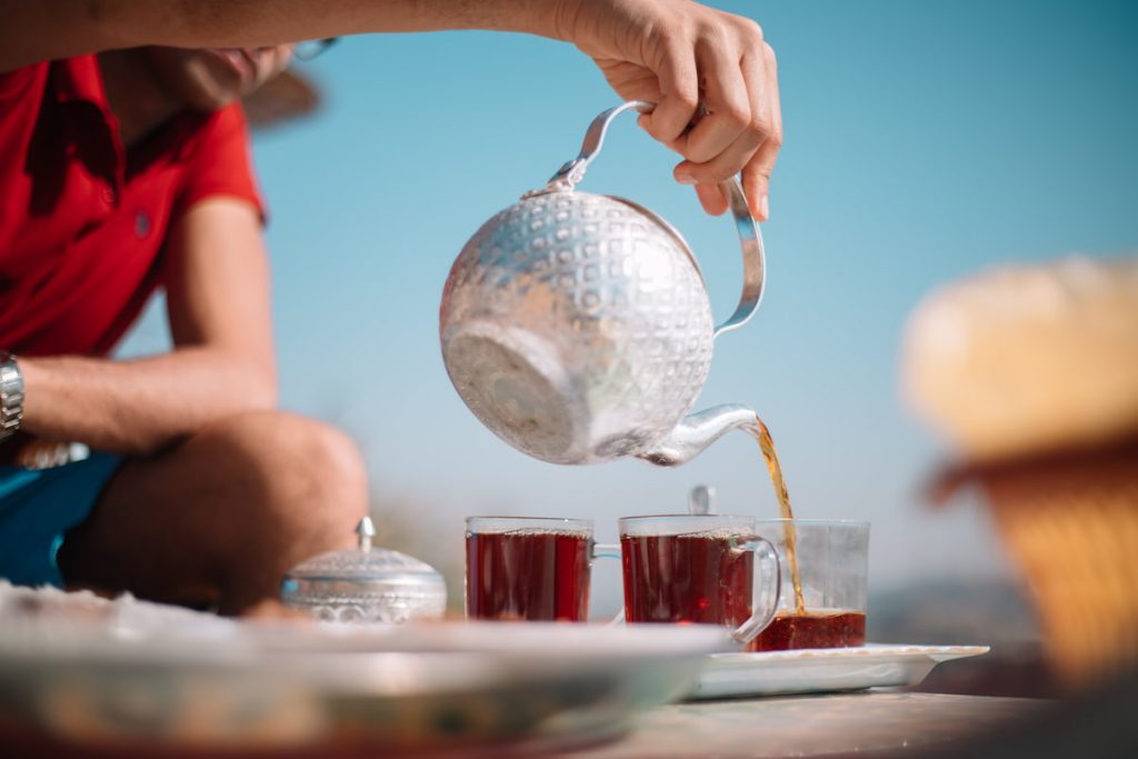a tourist pouring tea in aswan egypt