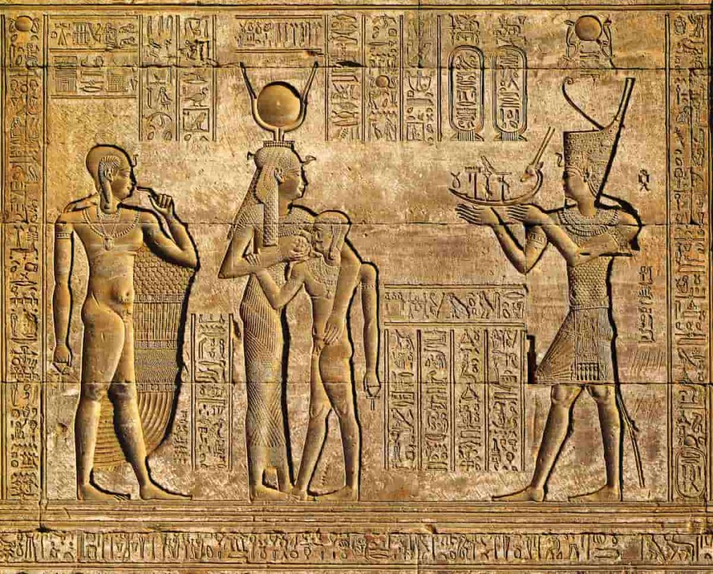 Hieroglyphic carvings on the exterior walls of an ancient egyptian temple