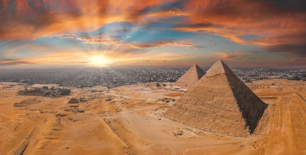 Magical sunset over the Egyptian pyramids. Aerial view of the Pyramids of Giza in Egypt.