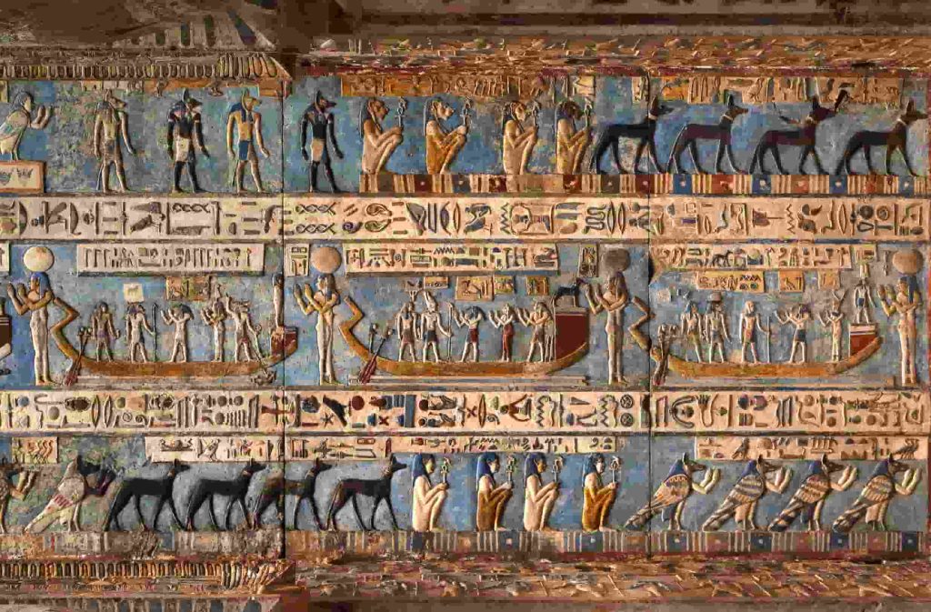 Hieroglyphic carvings and paintings on the interior walls of an ancient egyptian temple