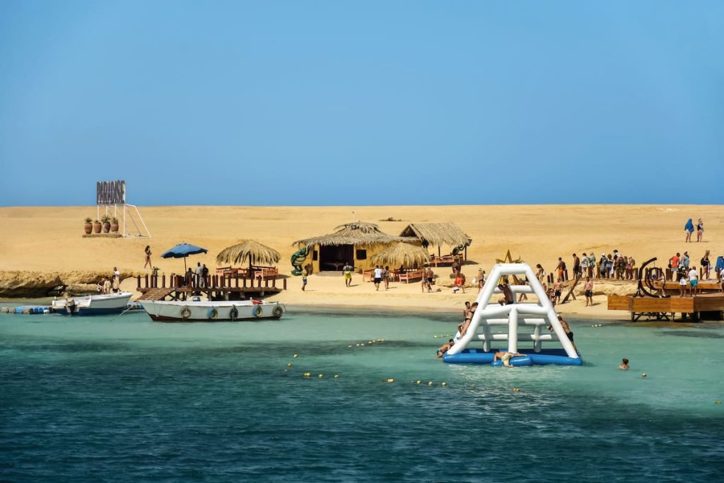 Beach holidays on PARADISE Island. People sunbathe and swim in Red Sea.