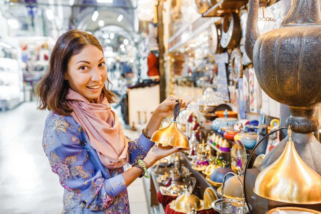 Woman tourist walking among countless shops in Grand Bazaar