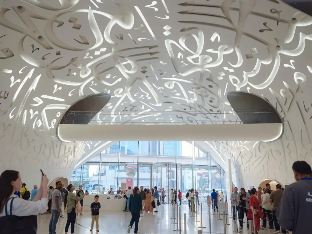 Museum of future. Sunset time View. Unique close up perspective. Urban background. tourist trip to futuristic Dubai, entrance hall interior with spiral stairs and tourists