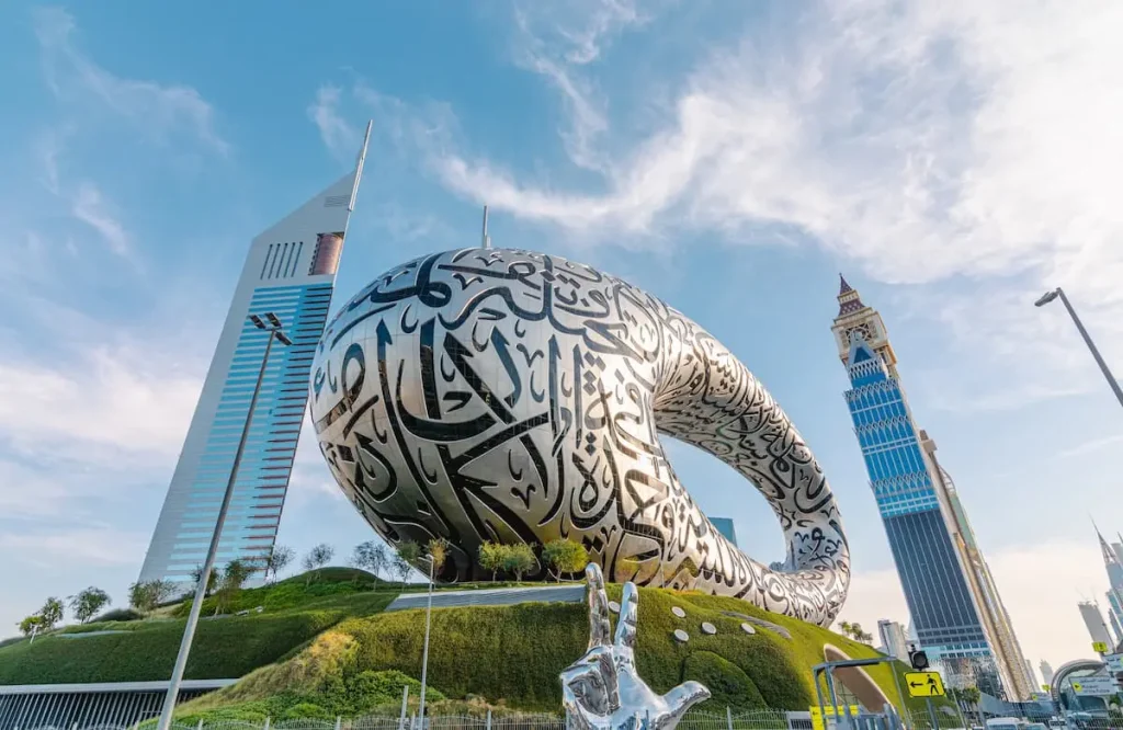 Three finger salute hand sign and Museum of the Future in Dubai
