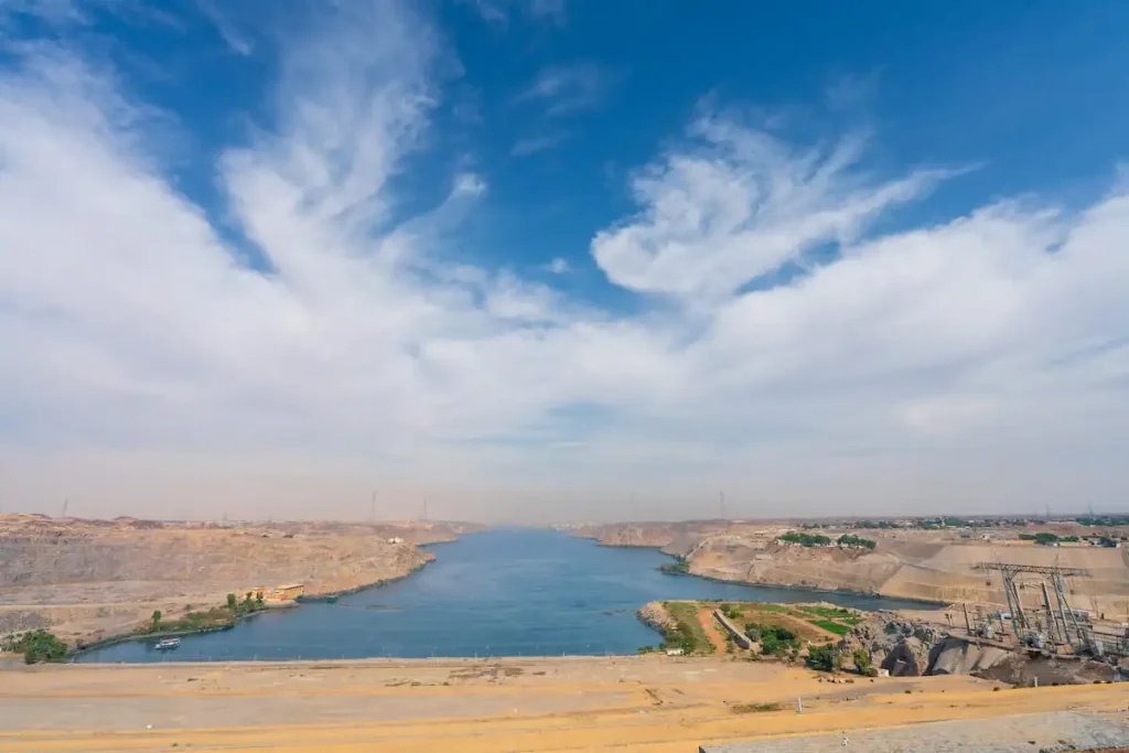 Wide-angle video of the Aswan High Dam showing Lake Nasser and surrounding desert in early spring daylight.