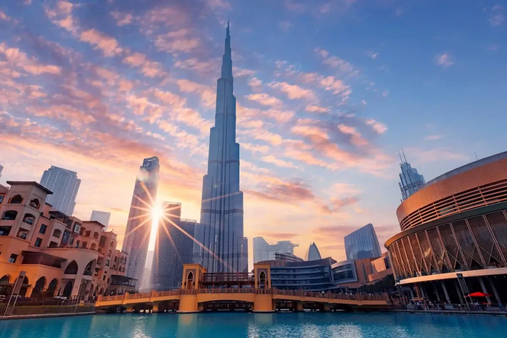 Cityscape Dubai panorama, Famous tourist landmark of city, sunset time. Modern center skyscrapers of UAE, sun light.
