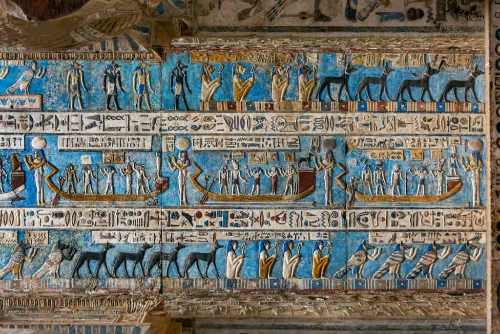Hieroglyphic carvings and paintings on the interior walls of an ancient egyptian temple