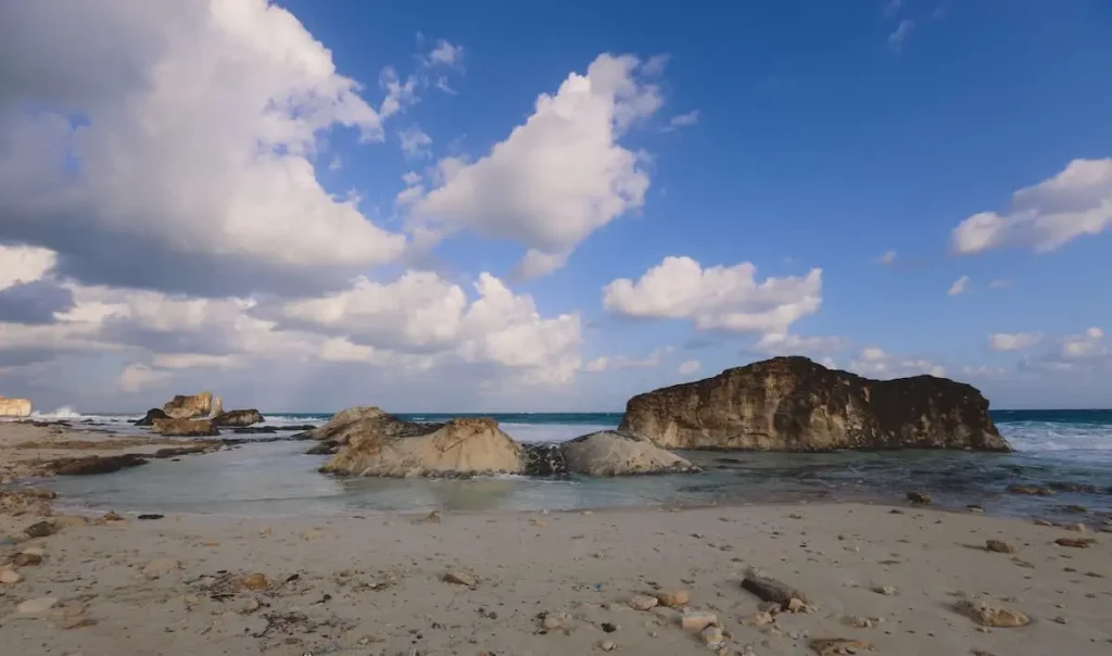 Windy and Rocky Coastline of the Mediterranean Sea in the Marsa Matruh city under Blue Cloudy sky with no People around, Egypt