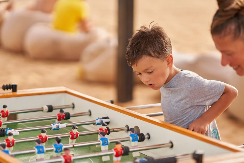 Mother plays table football with sons in Egypt Safaga