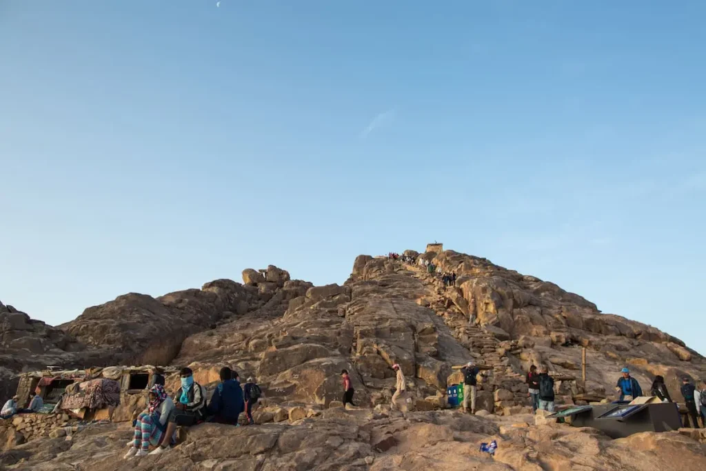 Pilgrims and tourists make the final climb to the summit of Mount Sinai in early morning, a sacred place of religious and historical significance