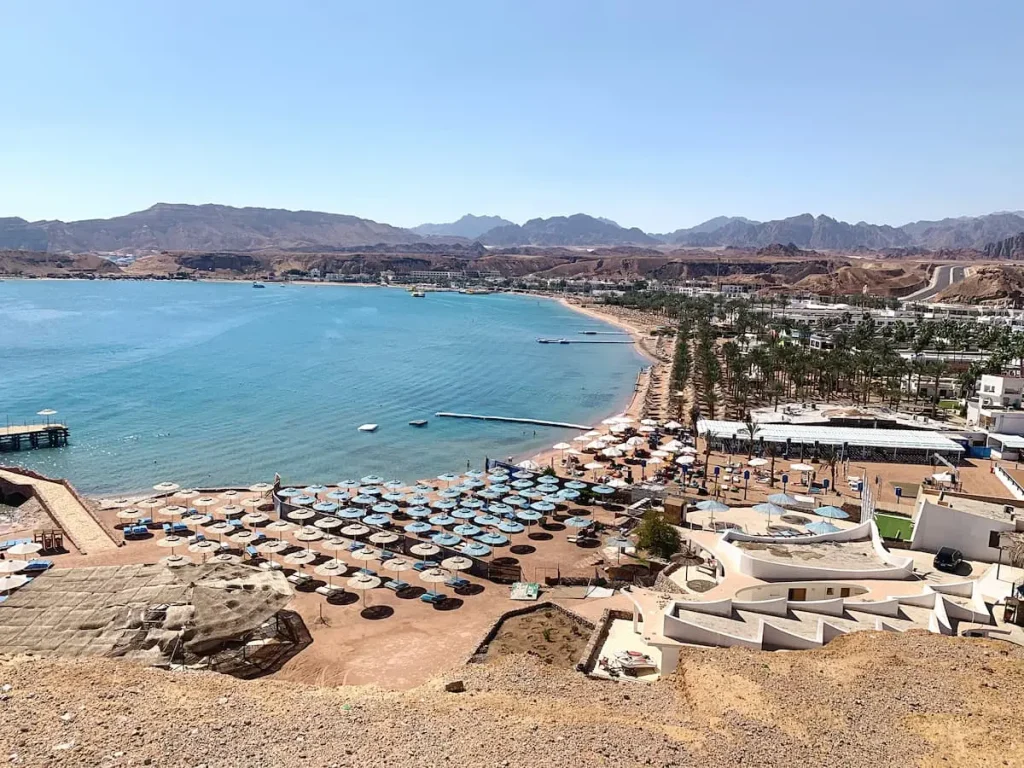 Sharm el sheikh, is an Egyptian resort town between the desert of the Sinai Peninsula and the Red Sea. It's known for its sheltered sandy beaches, clear waters and coral reefs. Naama Bay, with a palm