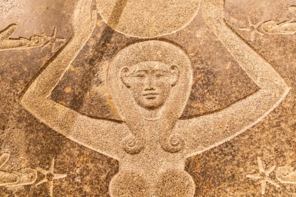  Carved stone relief of the goddess Hathor with a sun disk. Hathor was a major goddess symbolizing maternal aspects.