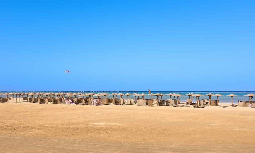 Wide empty beach with the blue cloudless sky, Egypt.