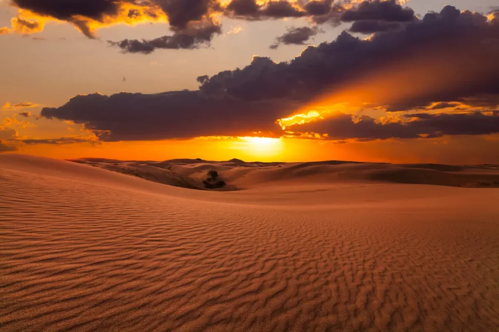 Beautiful sunset over the sand dunes in the Arabian Empty Quarter Desert, UAE. Rub' al Khali