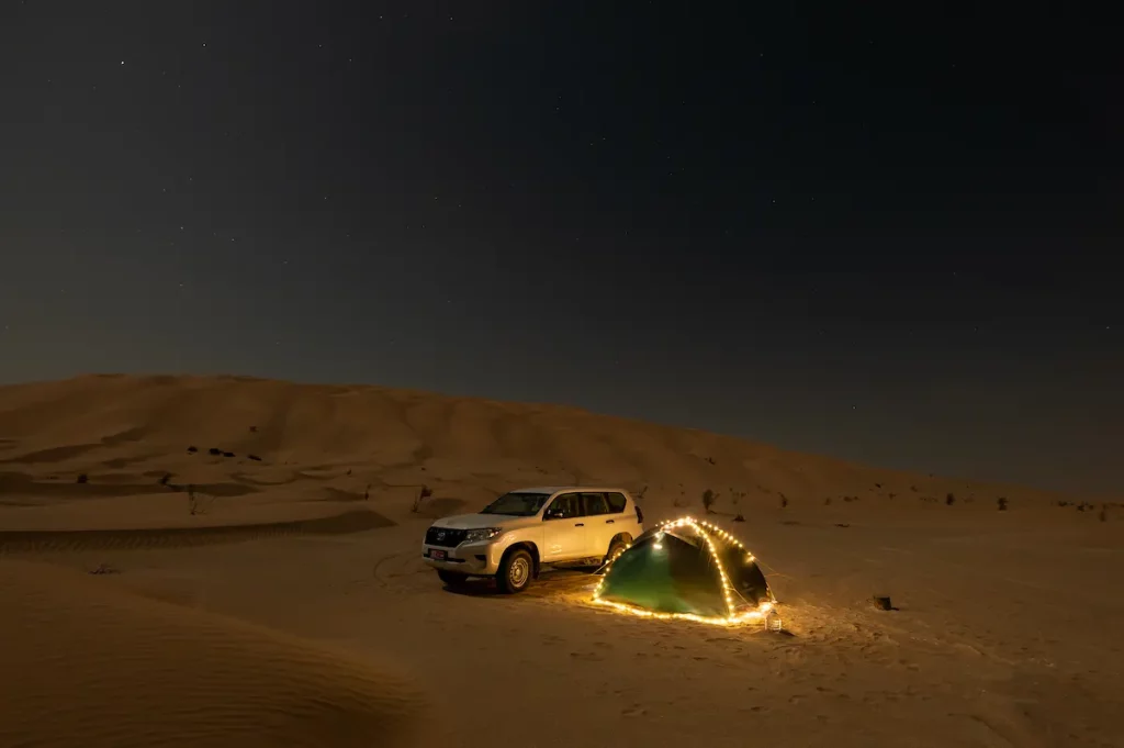 Overnight camping in high dunes desert with tent