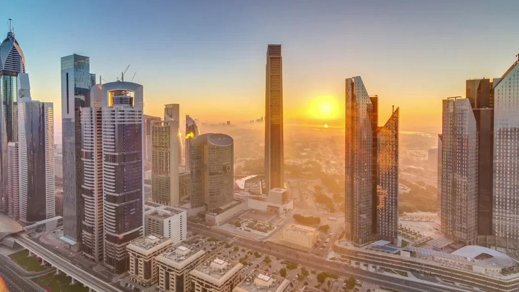 Sunrise over Dubai skyline in the morning, aerial top view to downtown city center landmarks timelapse. Famous viewpoint, foggy weather weather in dubai best time to visit. United Arab Emirates