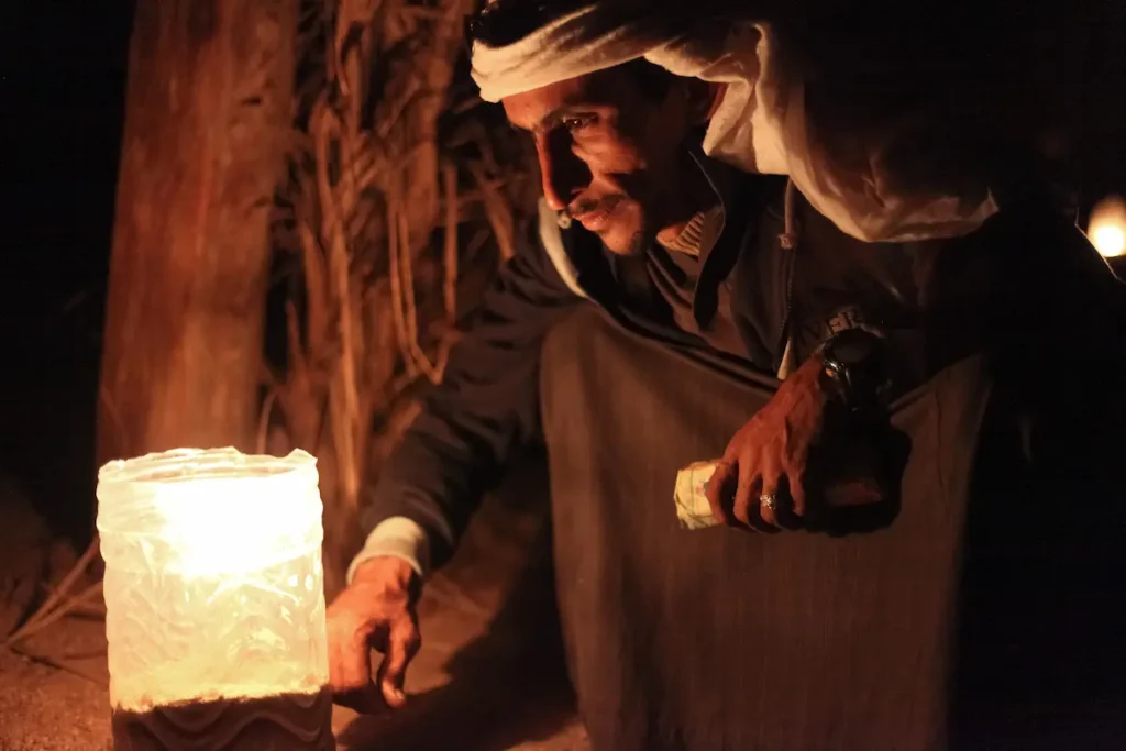  Bedouin sits by the light at night. Bedouin culture still survives in the Sinai, where there is a growing appreciation of its value and its fragility.