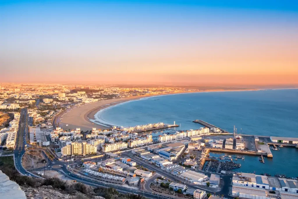 Agadir, Morocco at sunset. Panoramic view of Agadir city and bay in southern Morocco with Marina, beach and ocean from Oufla or Casbah fortress