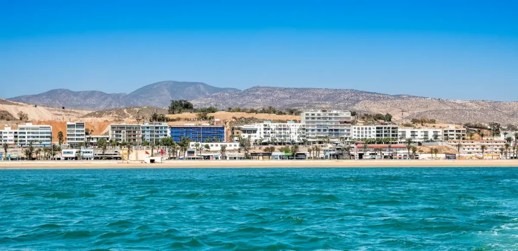 Seaside view of Agadir in Morocco. Popular tourist resort with bay, beach, promenade and hotels on coast of Atlantic ocean near Atlas Mountains in West Africa