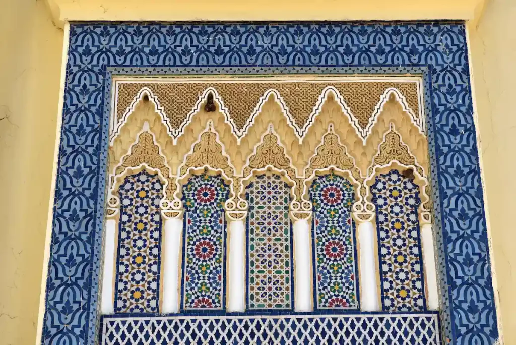 Architectural detail in Fez Royal palace, Morocco. Carved stone and Arabeaque mosaic tilework