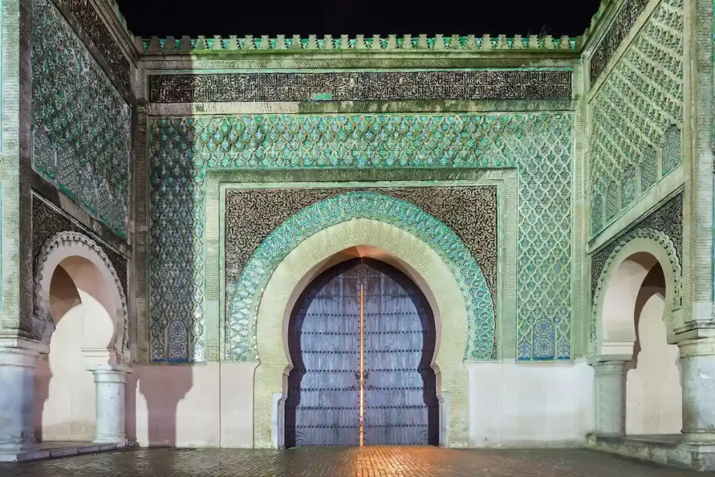The Bab Mansour Gate in Meknes, Morocco at night. Bab Mansour Gate named after the architect, El-Mansour. Bab Mansour is a main gate in Meknes, Morocco. 