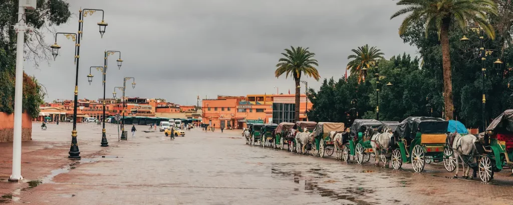 Marrakech, Morocco: Horse drawn carriages parked in Place Jemaa el Fna, on a rainy day, waiting for tourists Marrakech Attractions