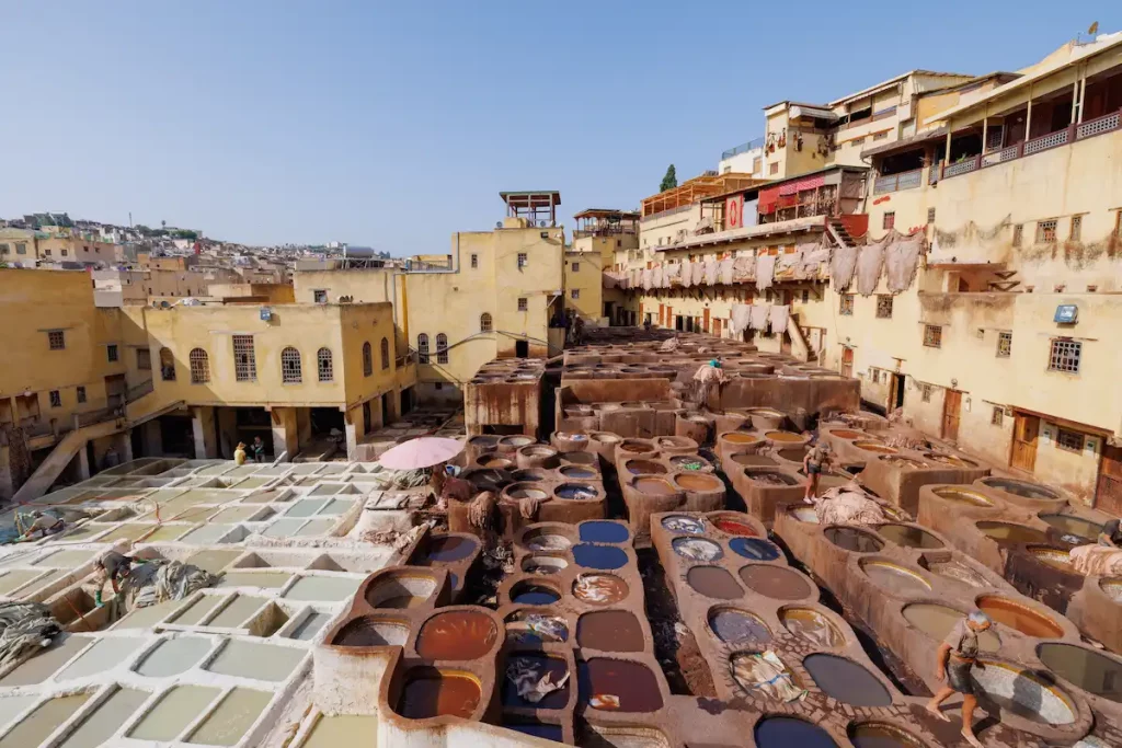 Workers treat leather with softening liquids and dyes at Chouara Tannery, in the Medina quarter of Fez el Bali, Fez, north west Morocco