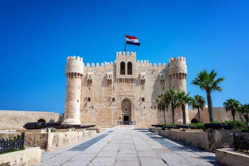 Citadel of Qaitbay with Egyptian flag flying above it in Alexandria, Egypt