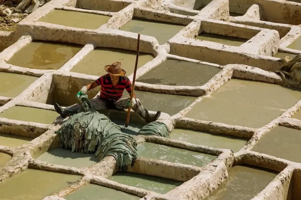  Chouara Tannery in Fez city. Workers dyeing the leathers in the vats for further process.It is the oldest and most tourist attractive tannery in Morocco.