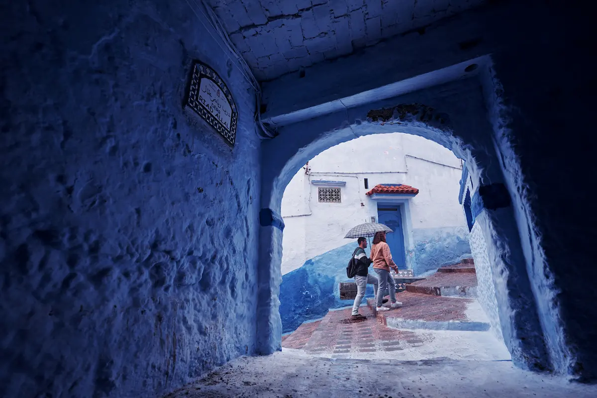 Tourists couples on street in medina of blue town Chefchaouen, Morocco. 19th of October 2018.