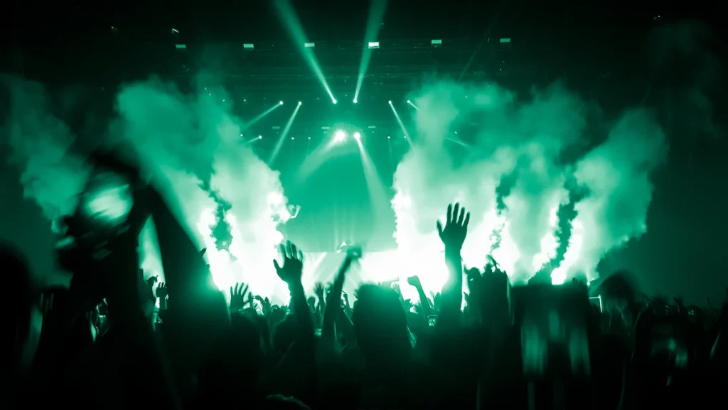 Happy people dance in nightclub DJ party concert and listen to electronic dancing music