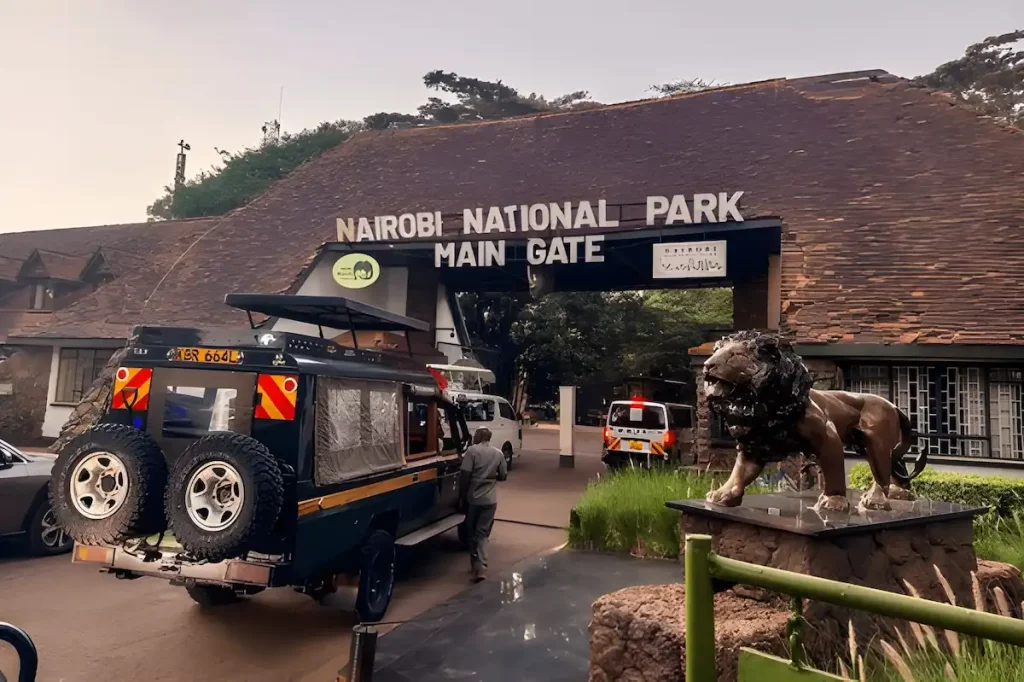 Land Cruisers and safari vans wait to enter the main gate of Nairobi National Park in Africa