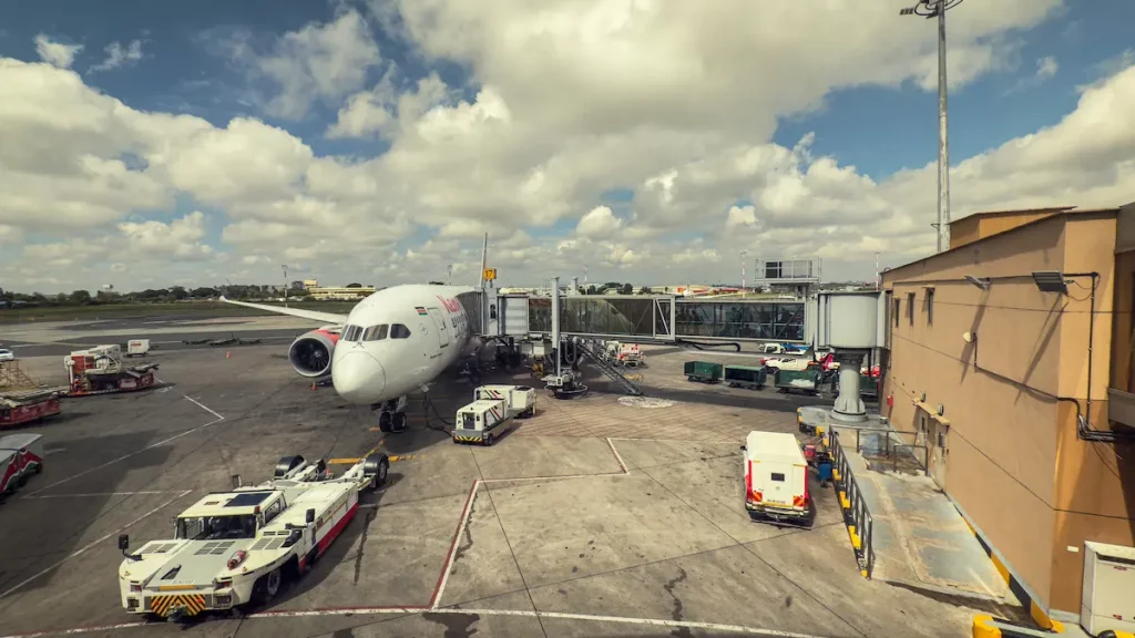  Commercial Airplane with Luggage and Service Vehicles at Jomo Kenyatta Internationaal Airport in Nairobi