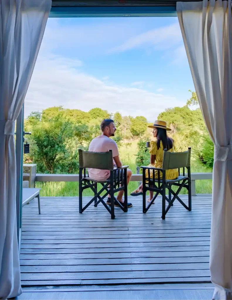 couple on safari in South Africa, Asian women, and European men at a tented camp lodge during the safari.