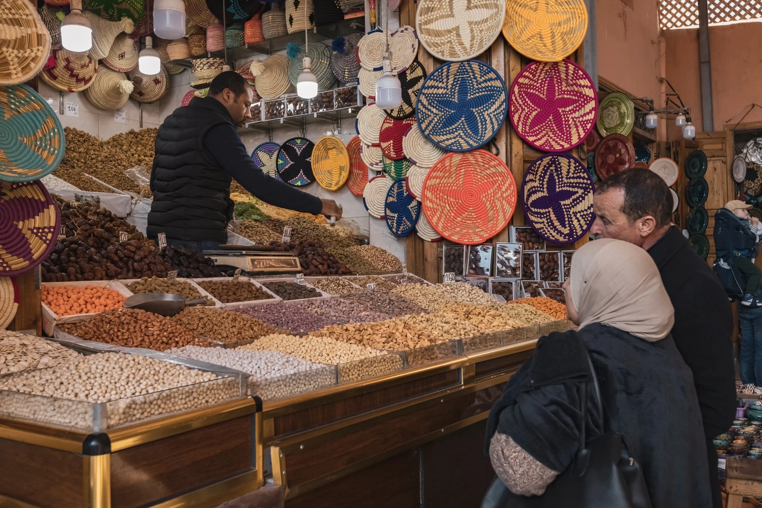 MOROCCO - January 19, 2025: Arab couples shopping at the old market in Medina buying spices and sweets in Marrakesh Morocco