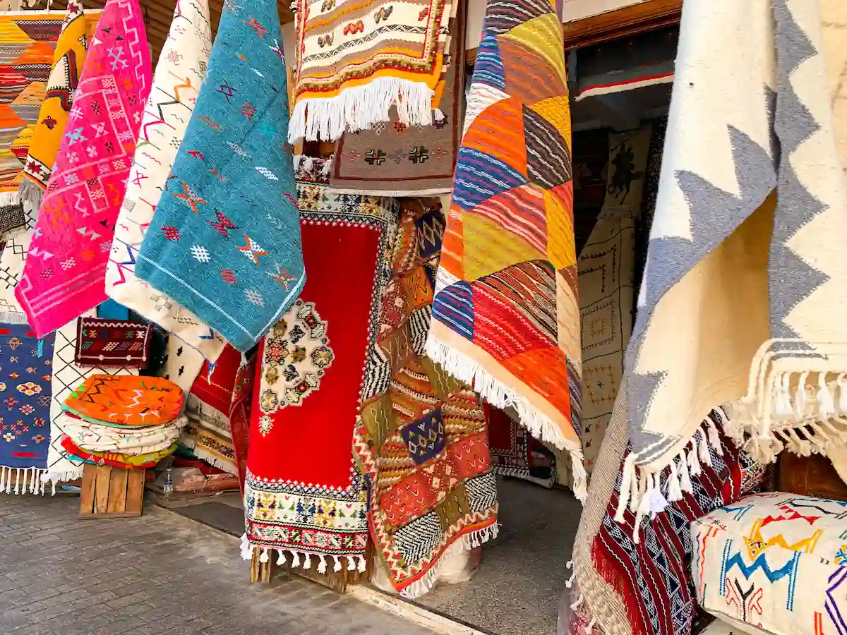  Colorful moroccan carpets with oriental ornaments for sale on a street shop in loudaya's old city of rabat of Morocco. Artistic picture. Beauty world. 