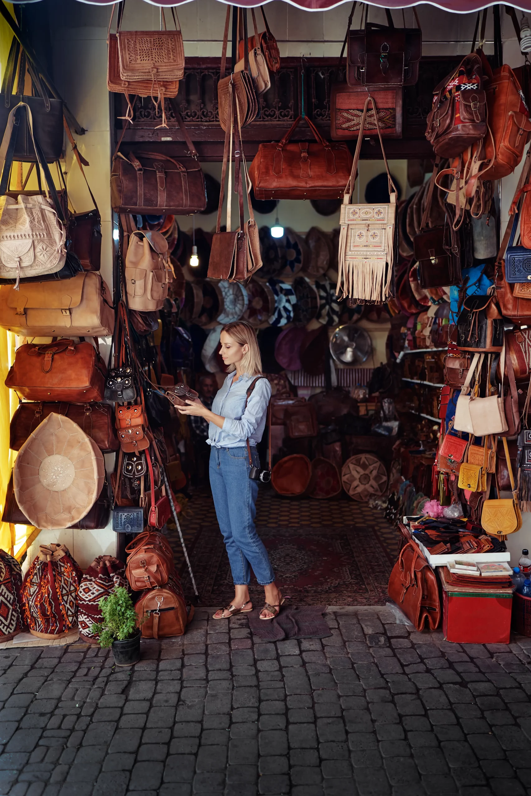 Travel and shopping. Young traveling woman with choose presents in bag shop in Morocco.