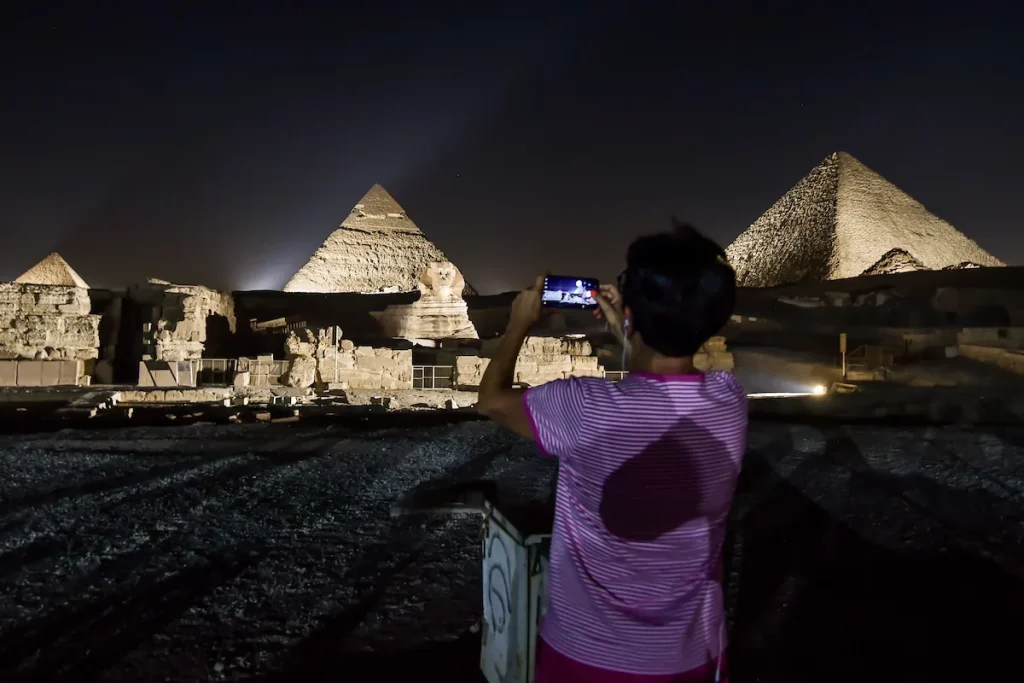 Pyramids of Giza illuminated in the evening hours within the World Tourism Day in Giza, Egypt