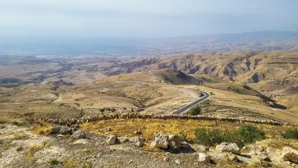 A beautiful aerial view of Mount Nebo in Jordan with a bit of misty weather as the sunlight is about to set where the Promised Land of the Jordanian desert valleys