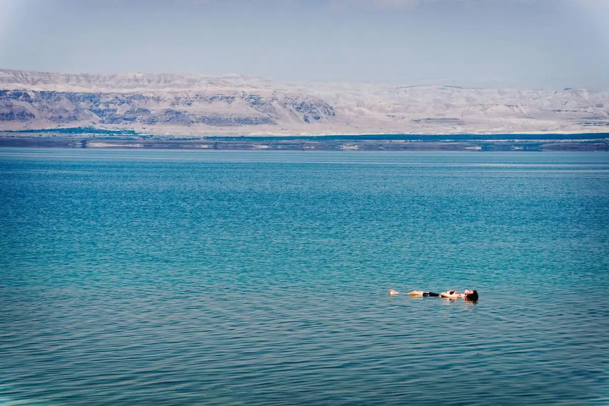 Person leisurely floating on surface of Dead Sea, Jordan