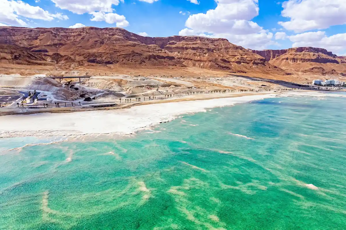 The Dead Sea. Resort for relaxation and treatment. Israel. Cloud shadows reflected in the water. The evaporated salt is collected on the water. Drone filming.