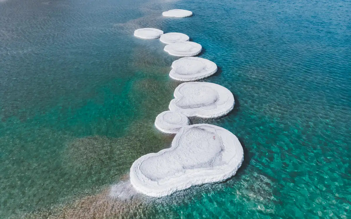 Aerial drone photo of Dead Sea salt islands in the middle of beautiful clear water
