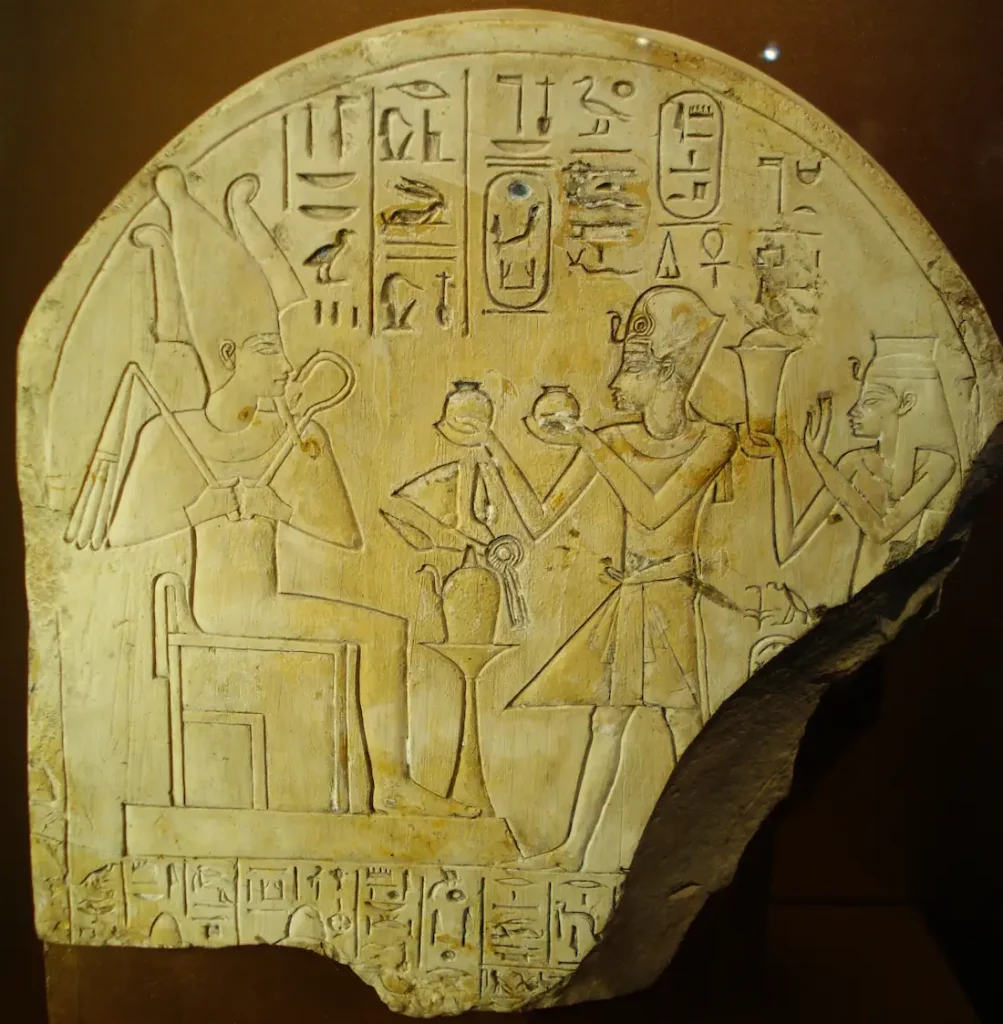 Posthumous stele of Amenhotep I and Ahmose-Nofretary making an offering to Osiris